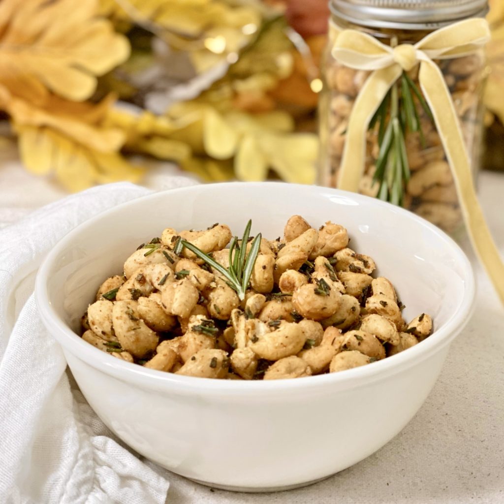 Roasted rosemary cashews in a white bowl.