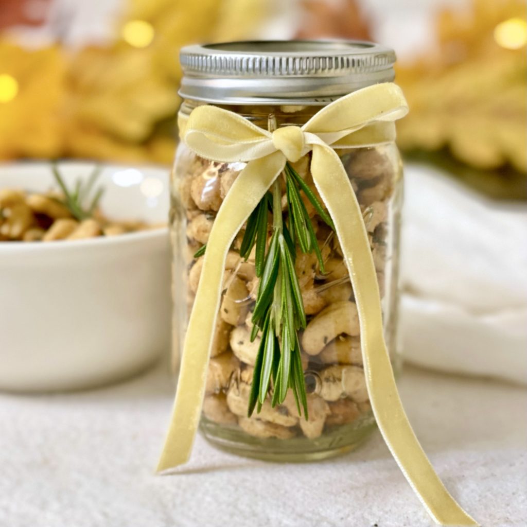 Roasted Rosemary Cashews in a mason jar with a ribbon around it.