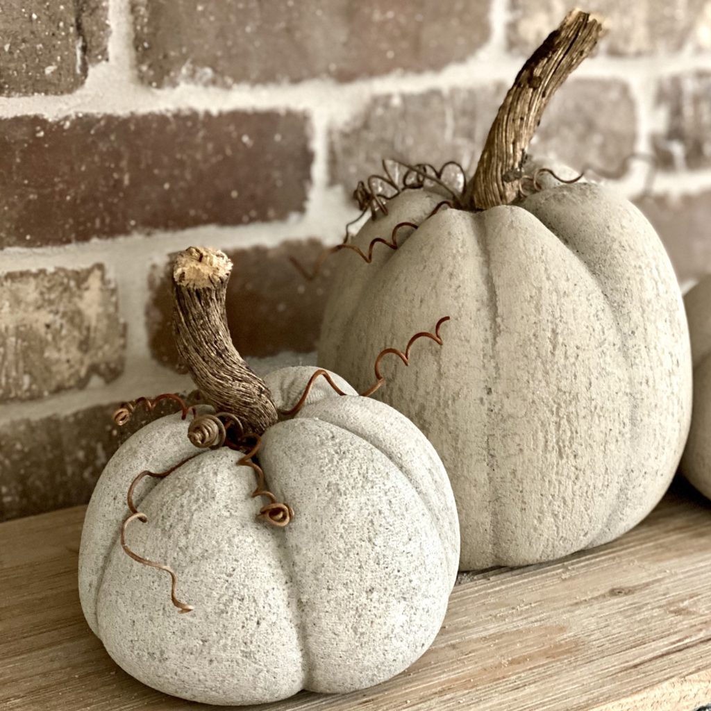 Close up of concrete pumpkins with brick background