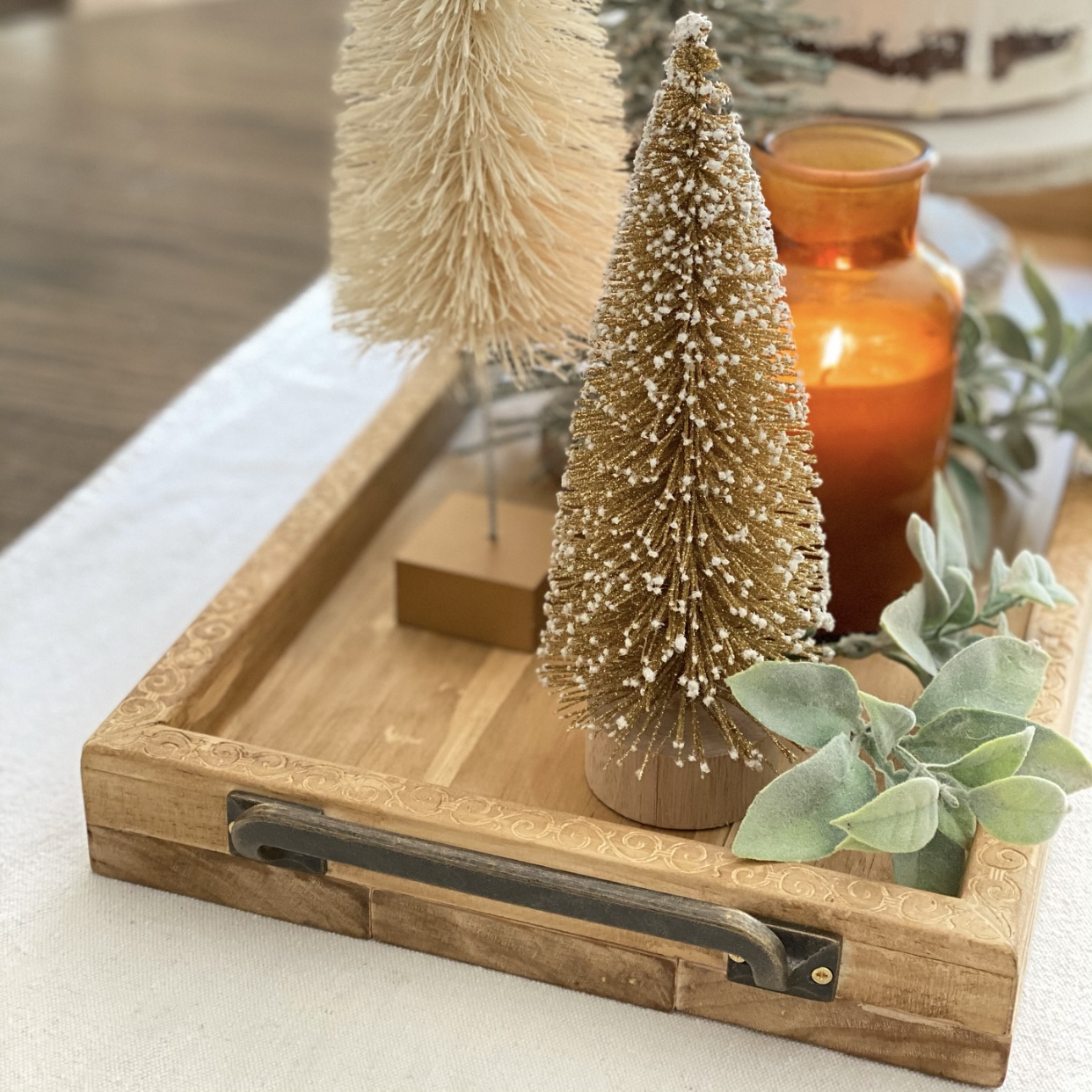 Side view of DIY Wood Farmhouse Tray with bottle brush trees on it.