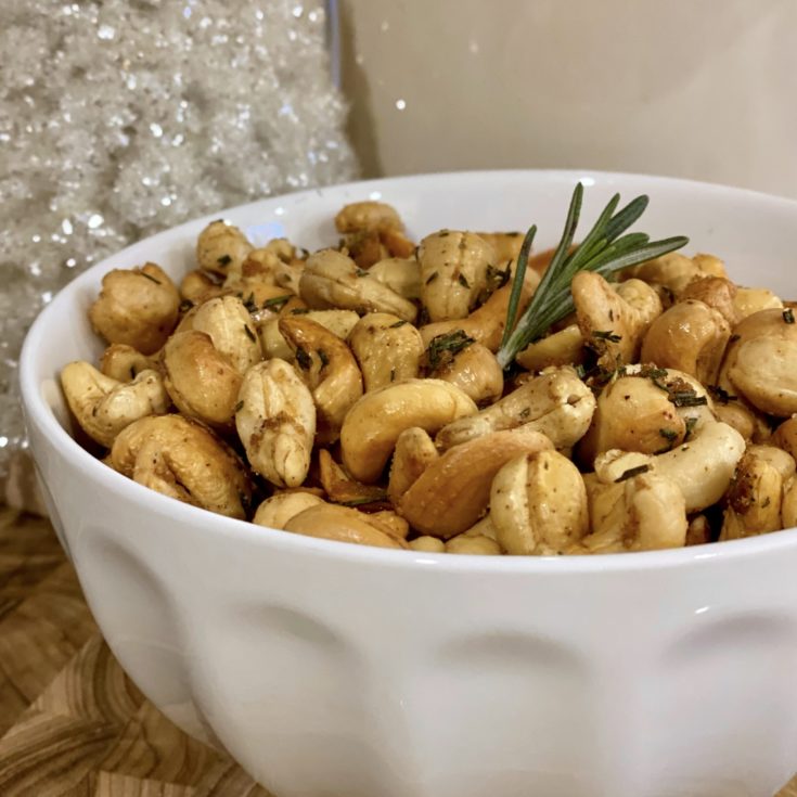 White bowl filled with Roasted Rosemary Cashews