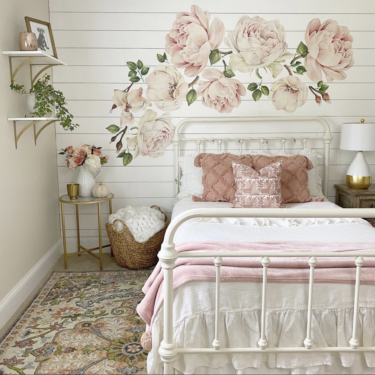 Girls bedroom with a shiplap feature wall and pink flower decals.