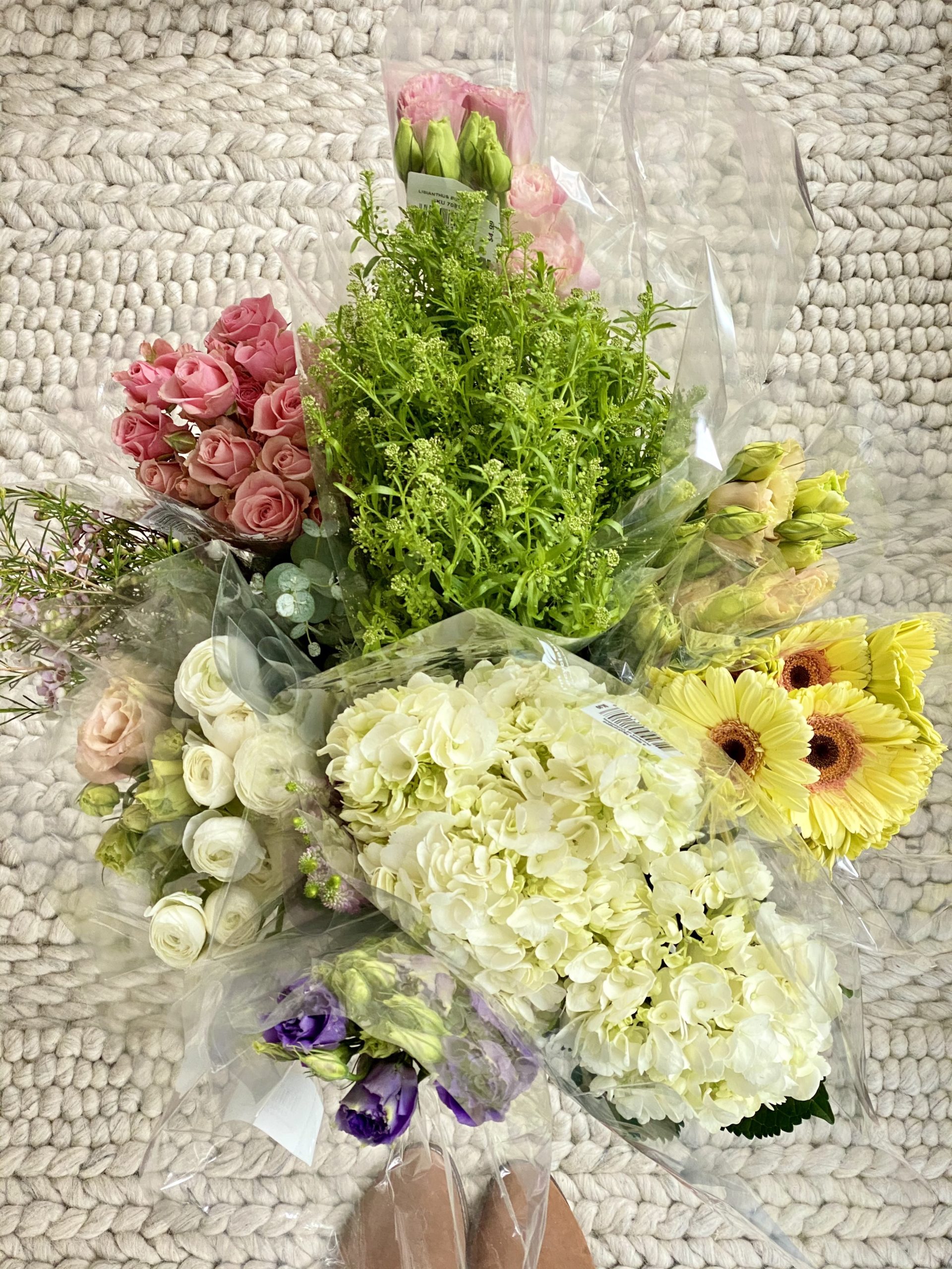 An arial view of a bucket of spring blooms to arrange in the DIY color block vase.