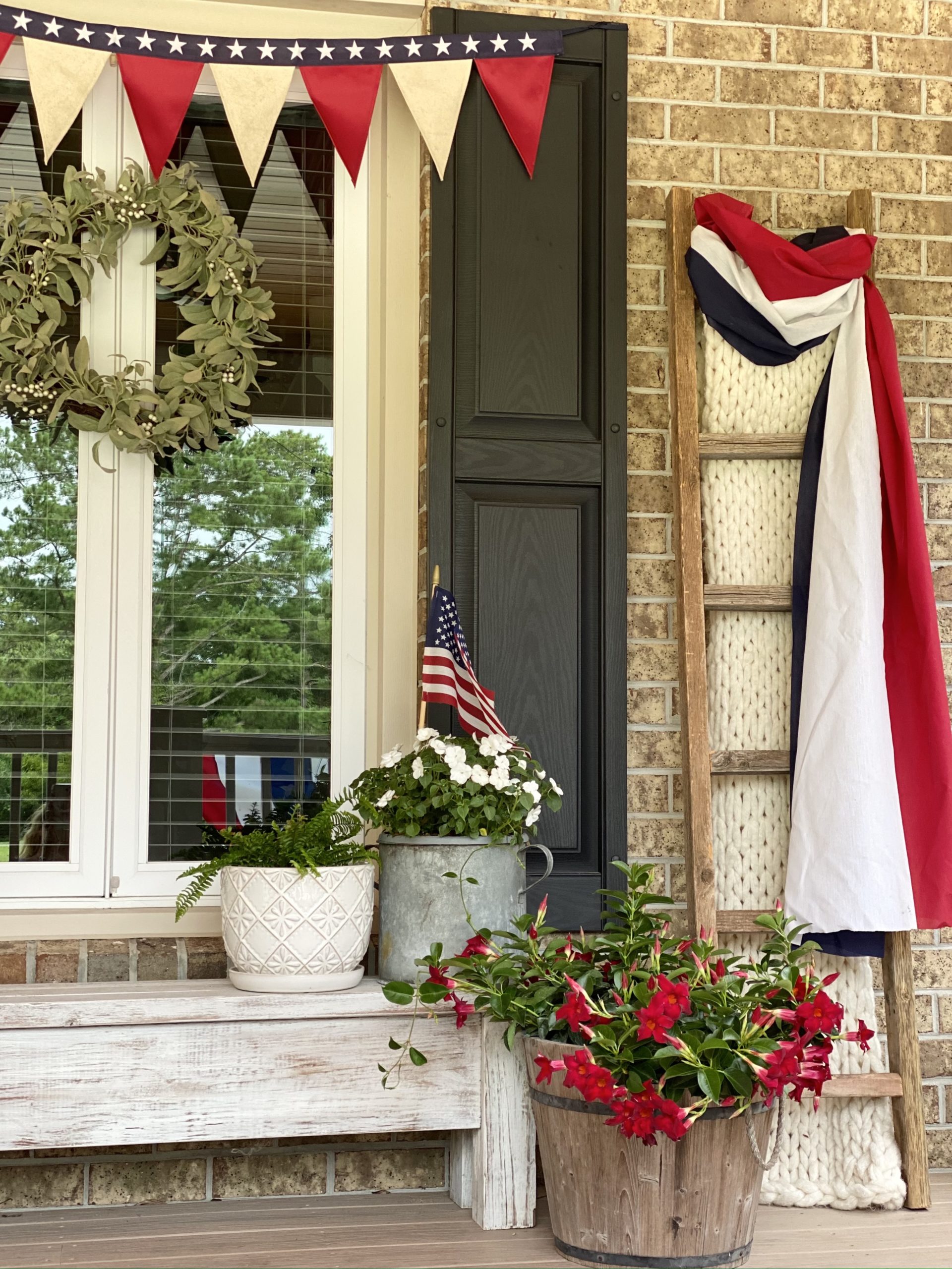 Blanket ladder draped in red, white, and blue cloth.