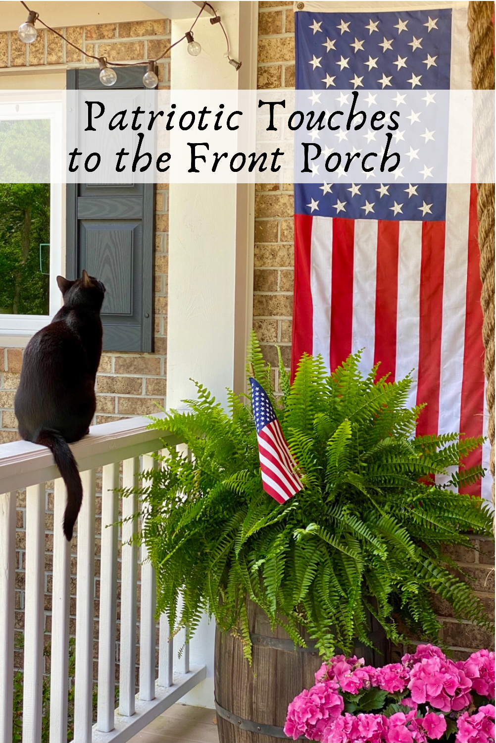 Pin for Pinterest. Black cat on the porch railing looking up at American flag on the wall of the front porch.