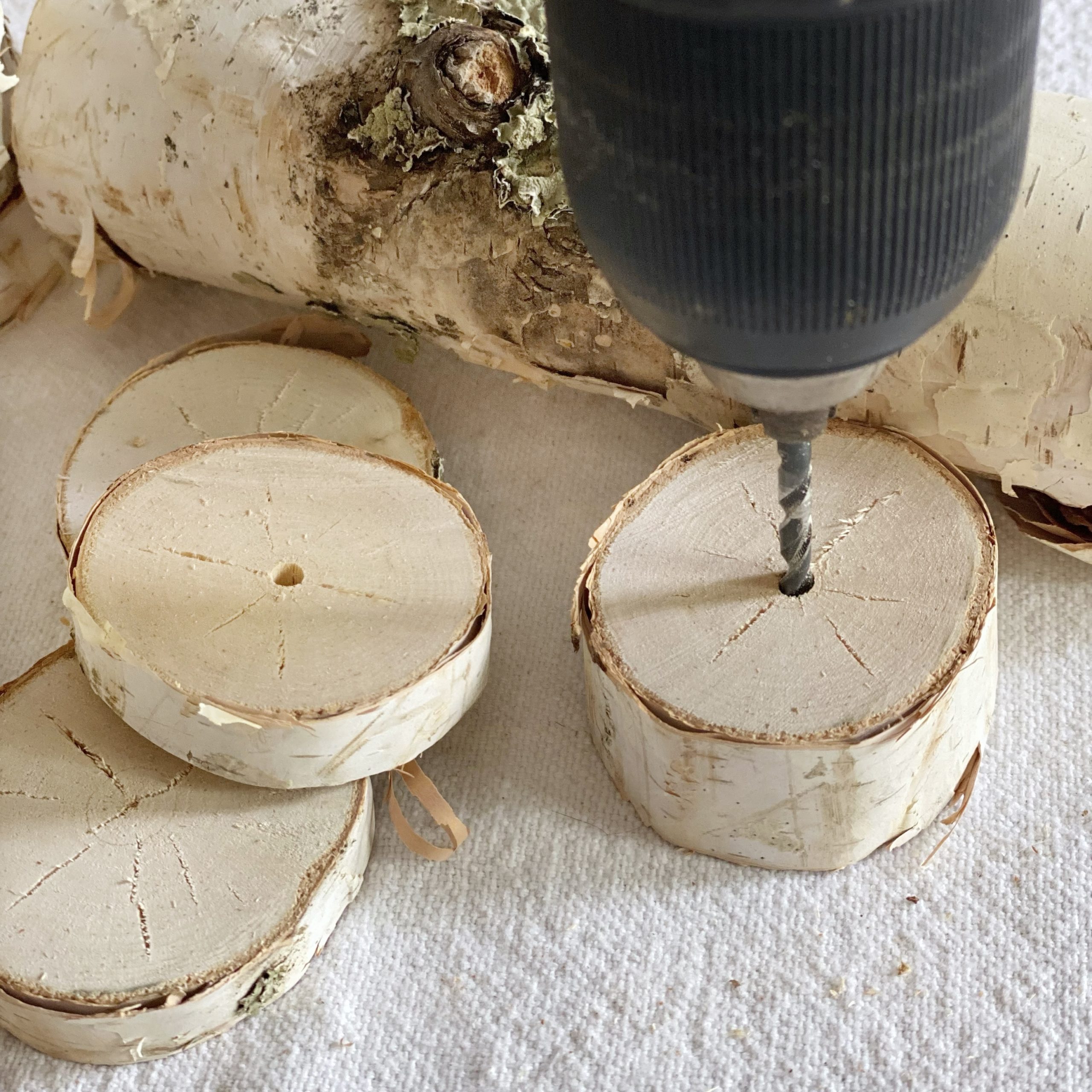 Drilling hole in the middle of the wood slice.