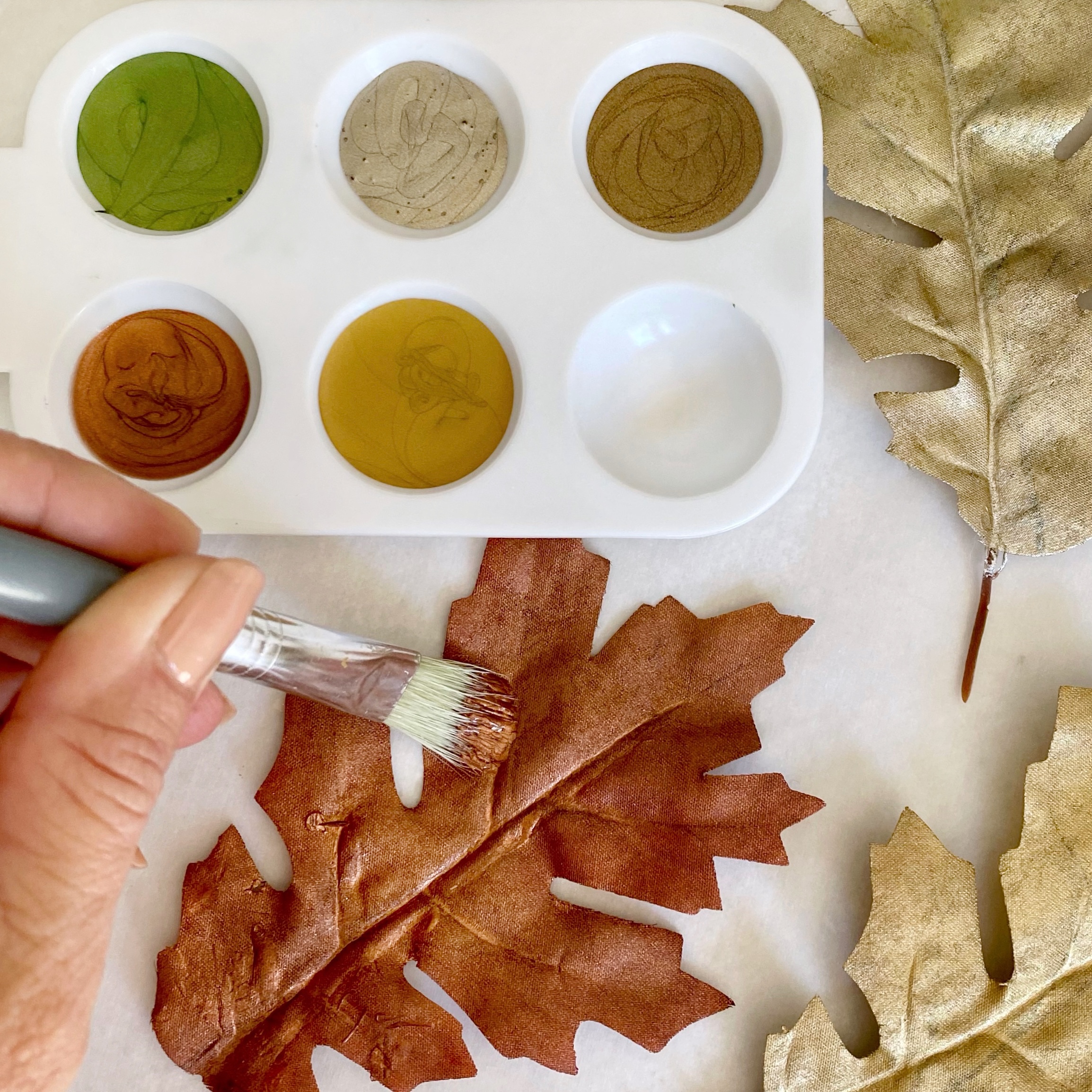 Painting faux Fall leaves with metallic copper paint.