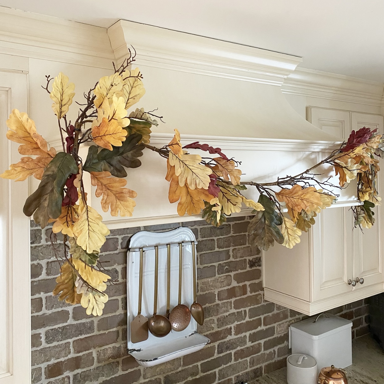 Up close view of Fall garland on the hood above the range in the kitchen.