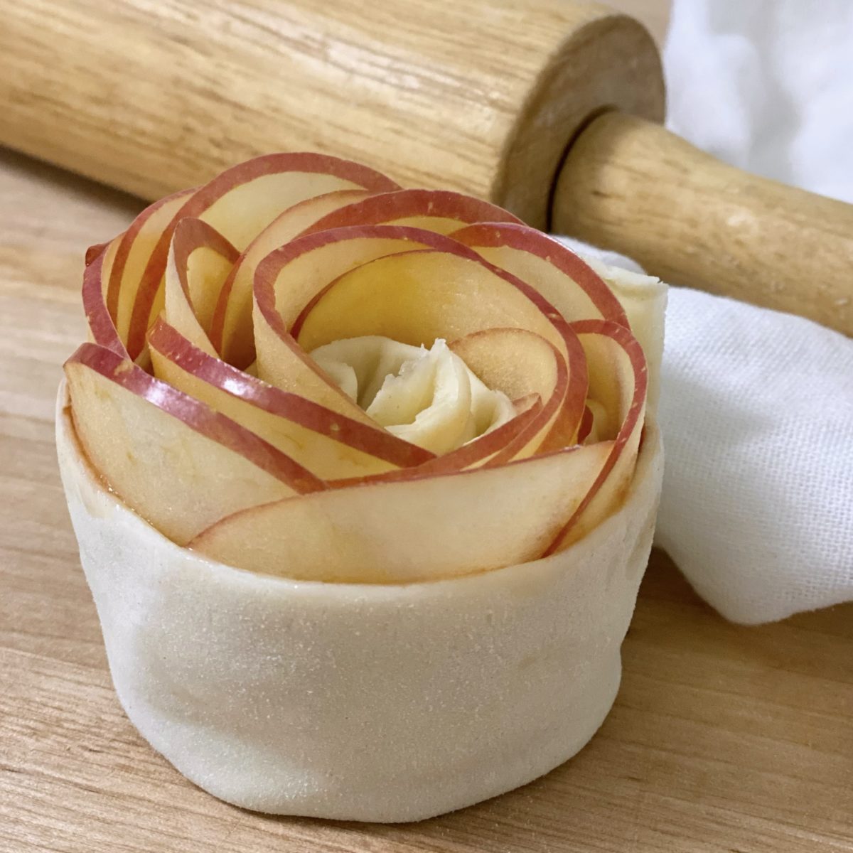 Single baked apple rose rolled up and ready to go in the muffin pan for baking.