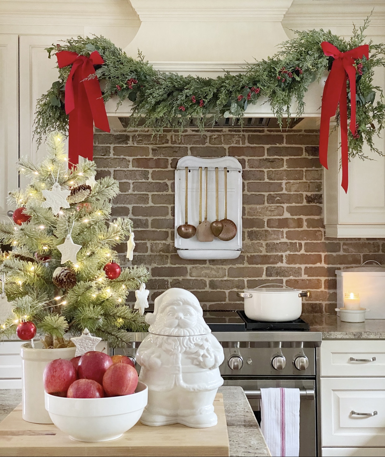 Christmas kitchen view with a mini Christmas tree on on the island with baking soda dough ornaments on it.