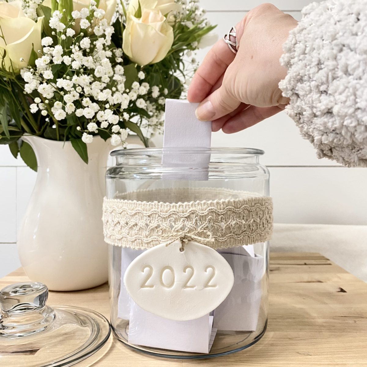 Placing a memory written on a card in the memory jar.
