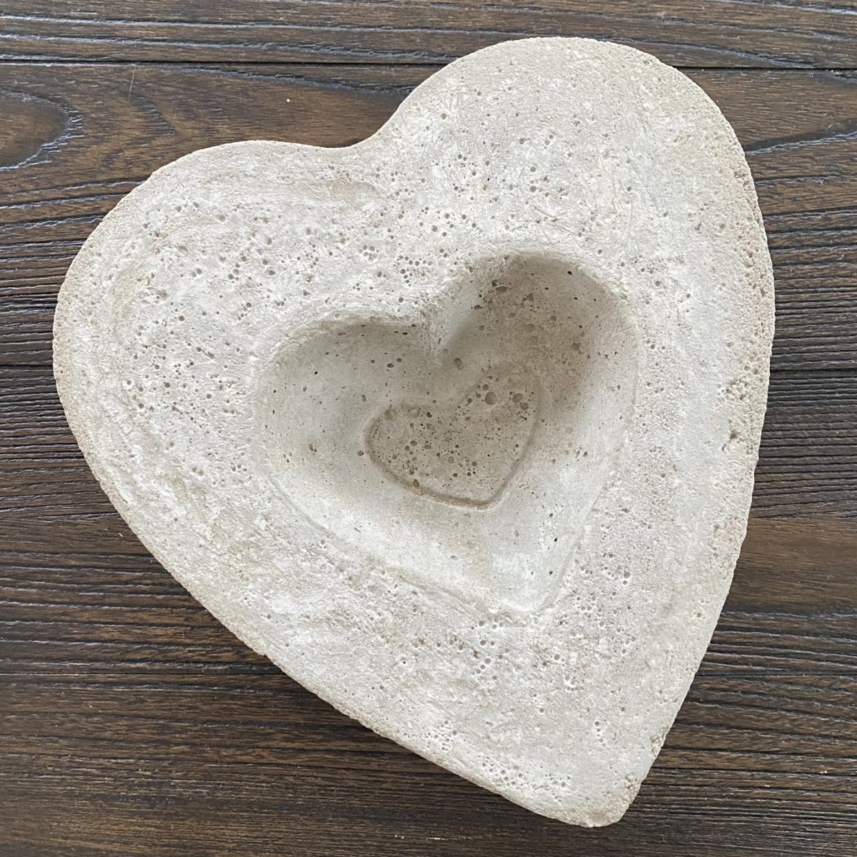 DIY concrete heart planter dry and out of the forms before plants are put in it.