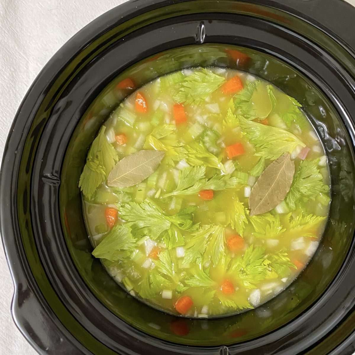 All the ingredients for my mama's split pea soup recipe in the crockpot ready to cook.