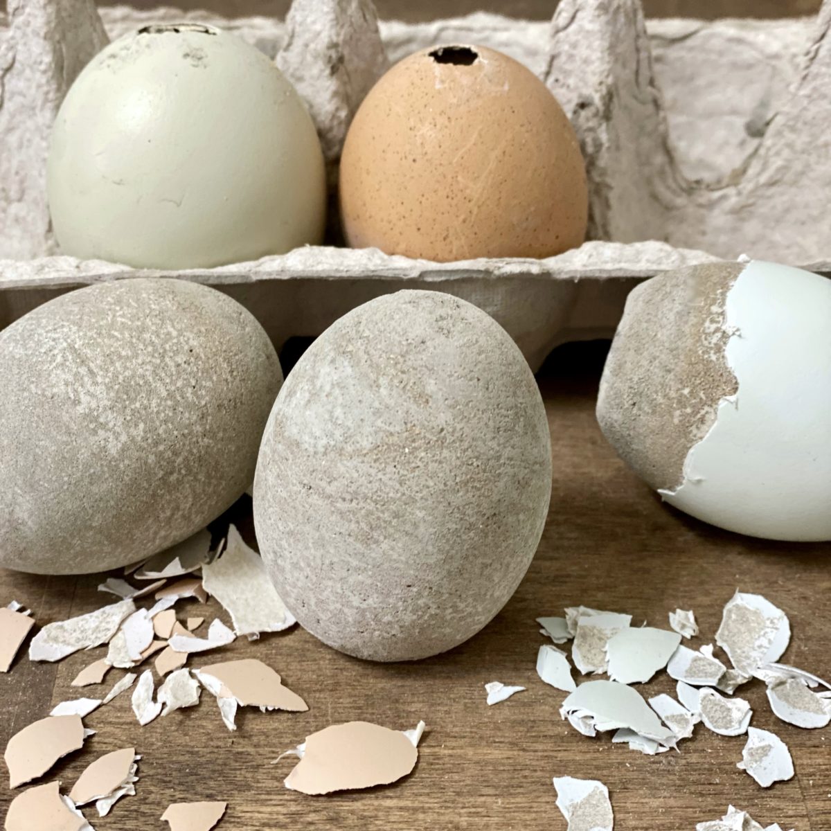 Peeling the eggshells to reveal concrete eggs inside.