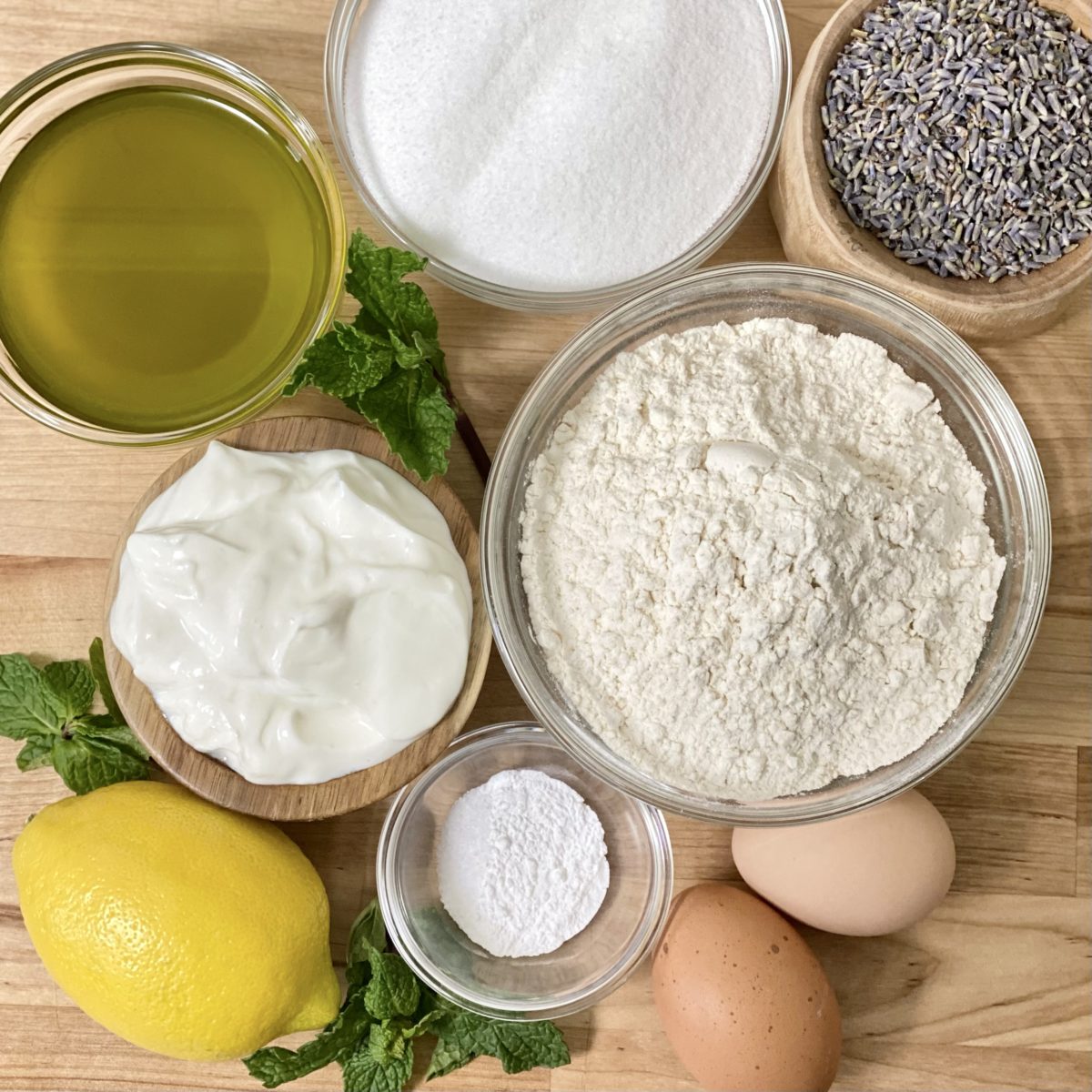 Ingredients for lemon and lavender cake including flour, sugar, lemon, lavender, olive oil, Greek yogurt, and more.