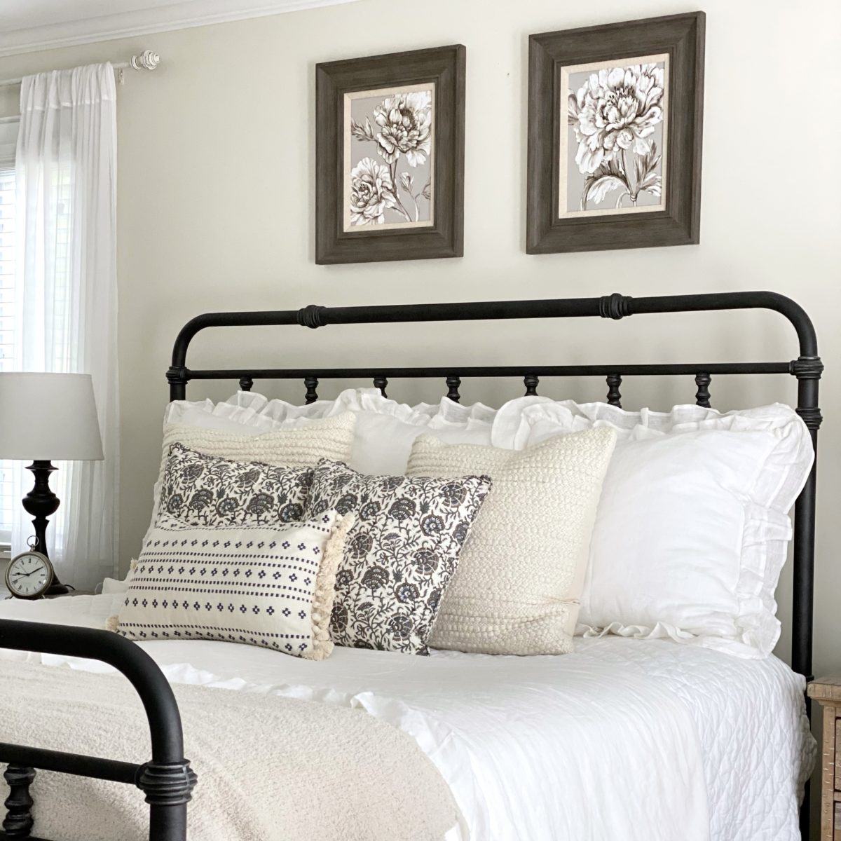 Simple summer bedroom white bedding with layers and florals.