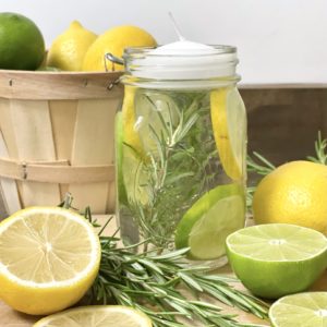 DIY mason jar luminaries made with a mason jar, water, rosemary, essential oils, vanilla extract, lemon and lime.