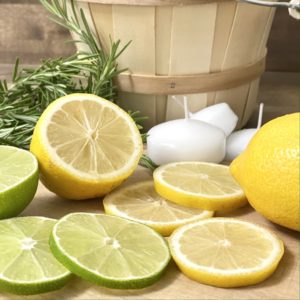 Slices of lemon and lime on a cutting board.