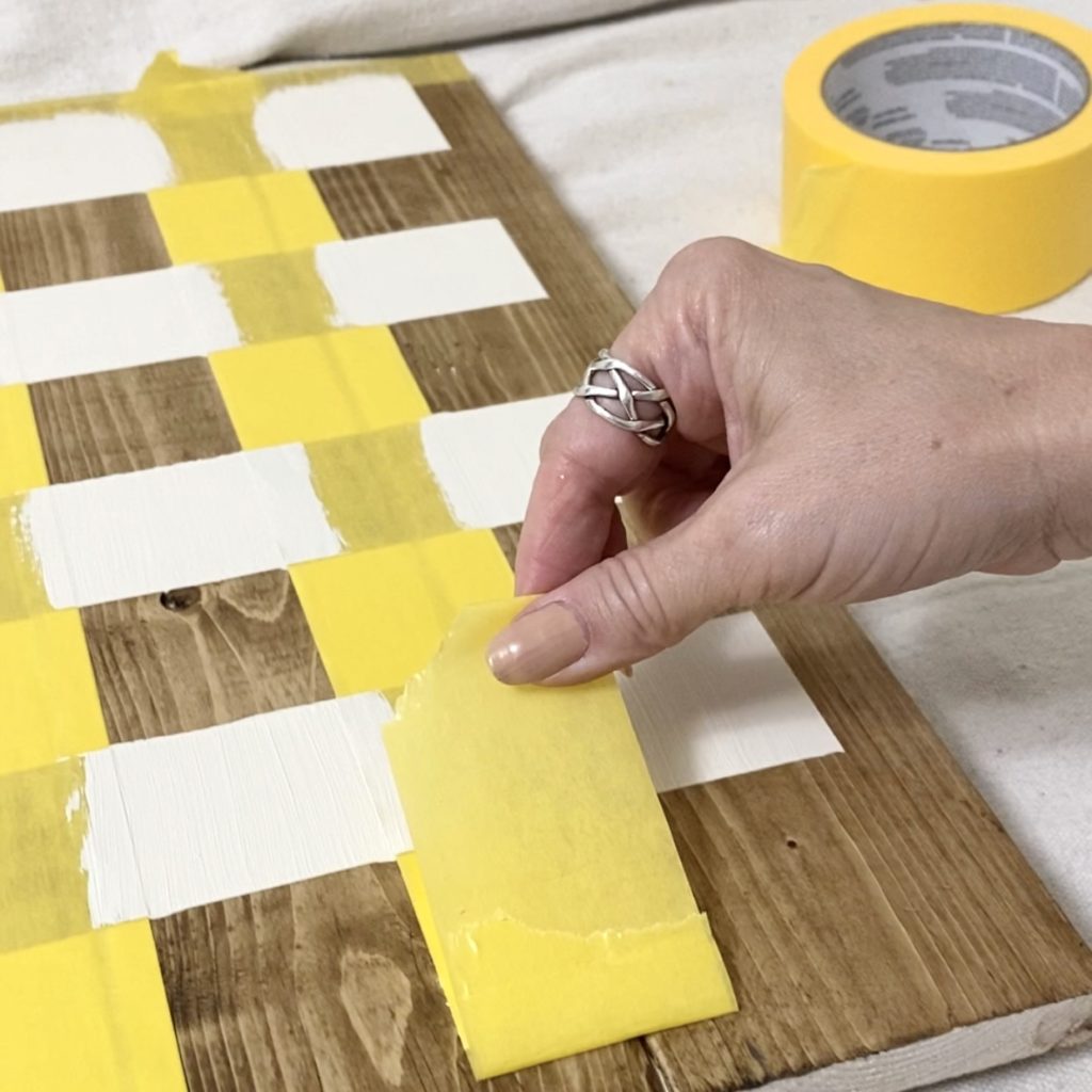 Removing the tape to reveal checker board pattern.