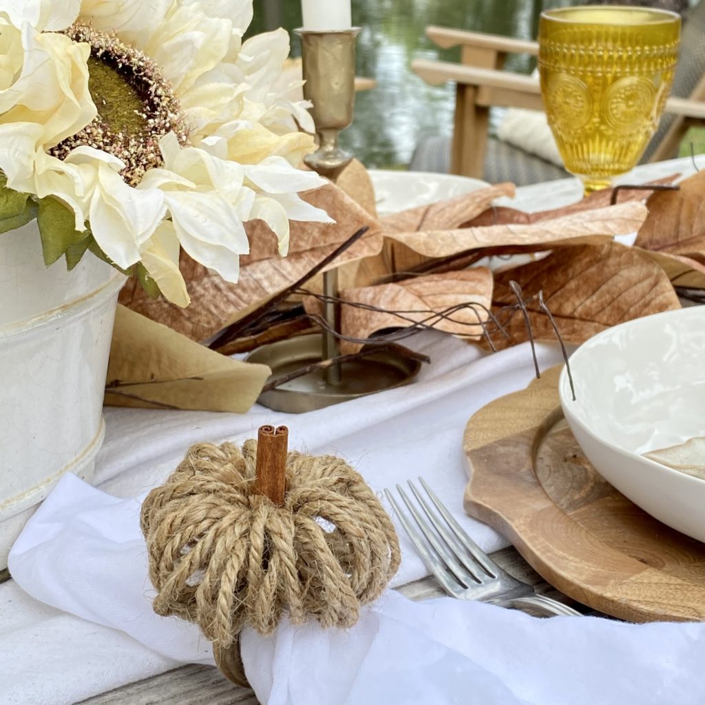 DIY pumpkin napkin holder on the table for a casual fall outdoor gathering.