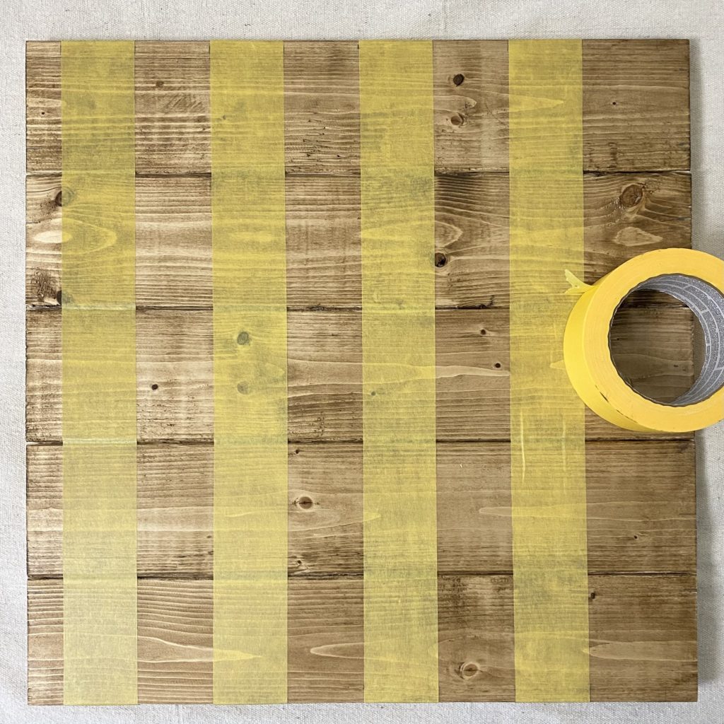 Four strips of painter’s tape stretched out on board 1.88 inches apart.