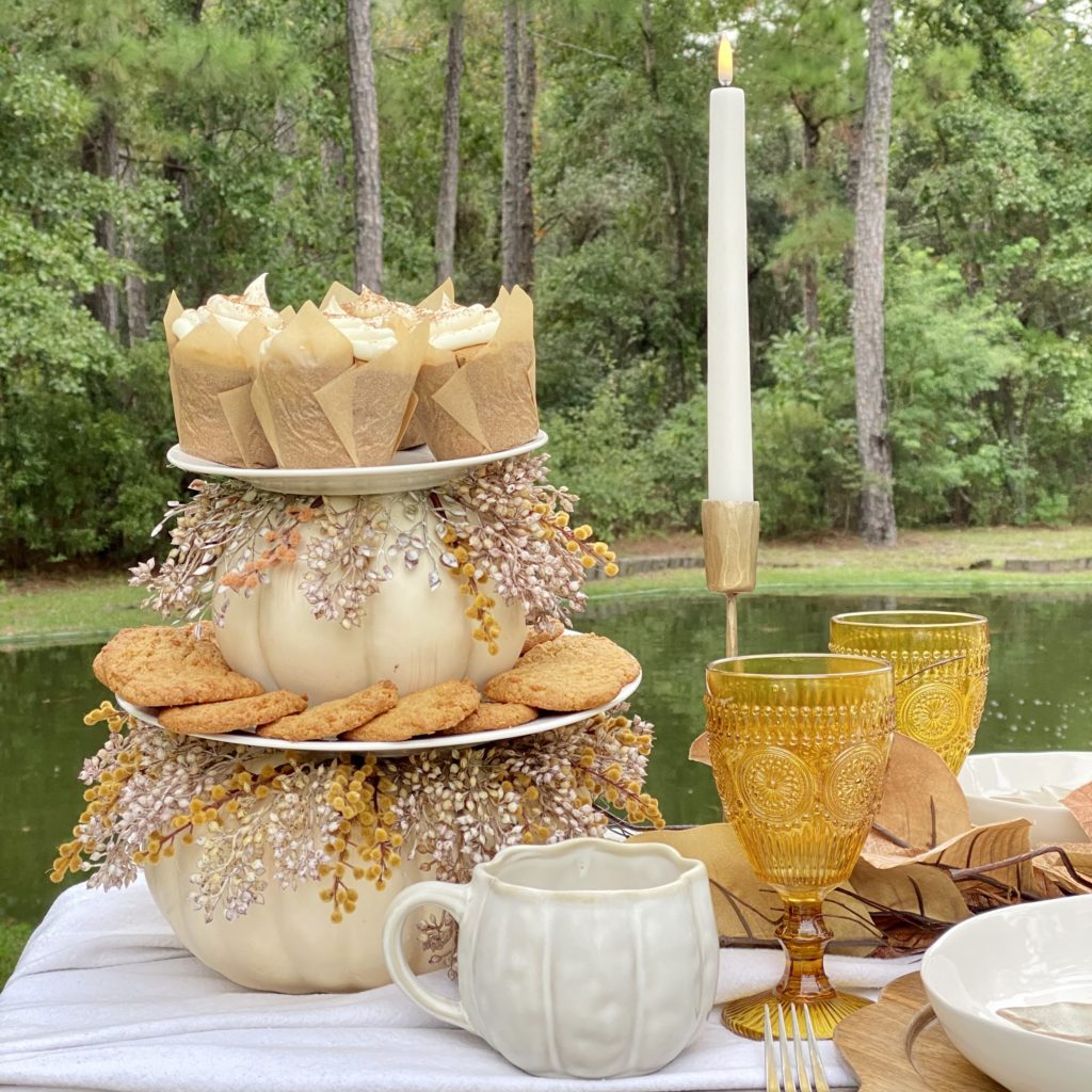 Fall tiered tray with Orange Spice Cupcakes and Pumpkin Spice Cookies on the picnic table.