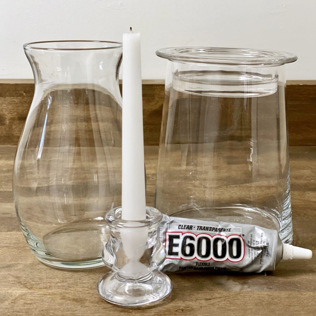 Everything you need to make a DIY glass hurricane lamp including a glass candle holder, a glass vase, and industrial strength glue.
