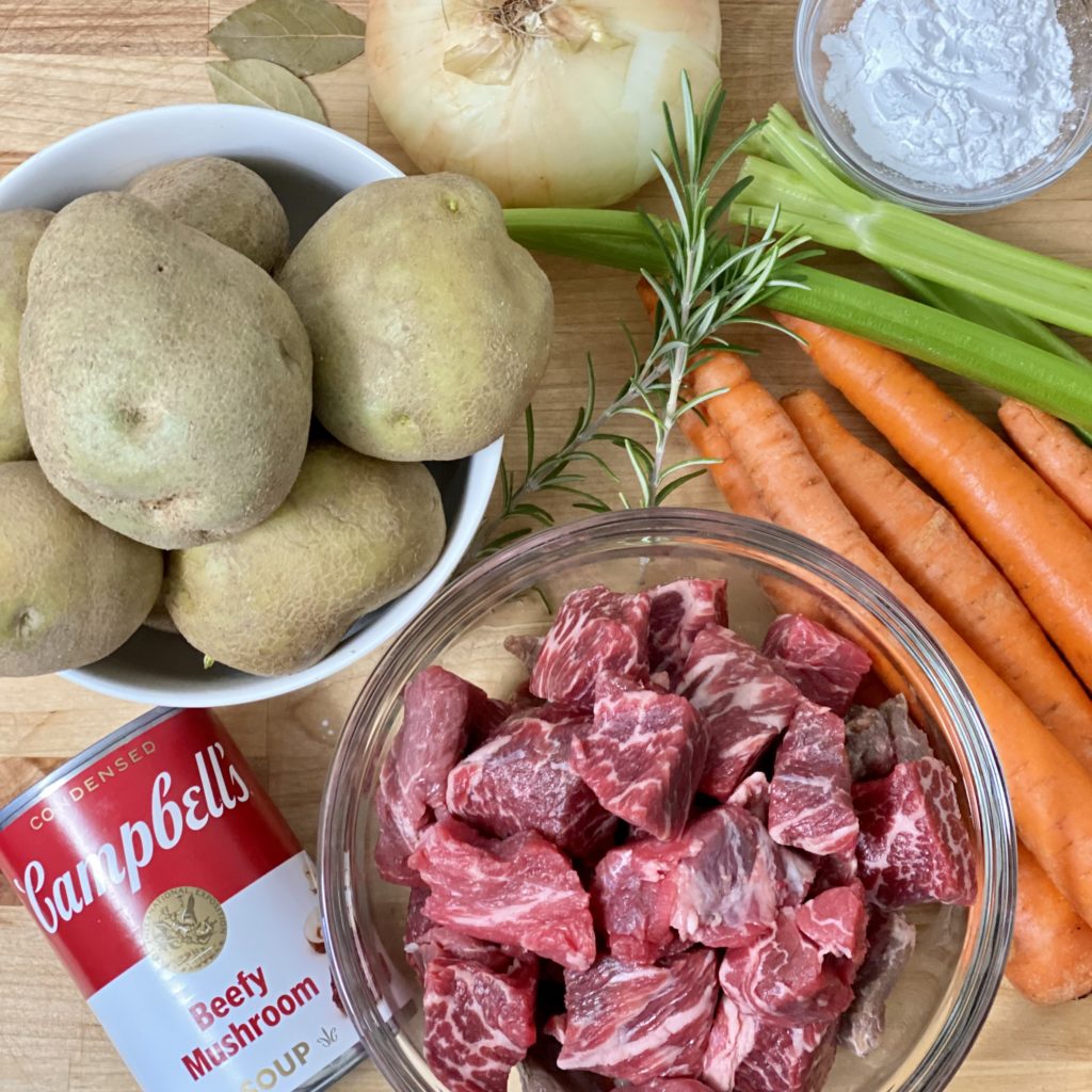 The ingredients in Oven Beef Stew including beef, carrots, celery, onion, Beefy Mushroom soup, Rosemary, and more.