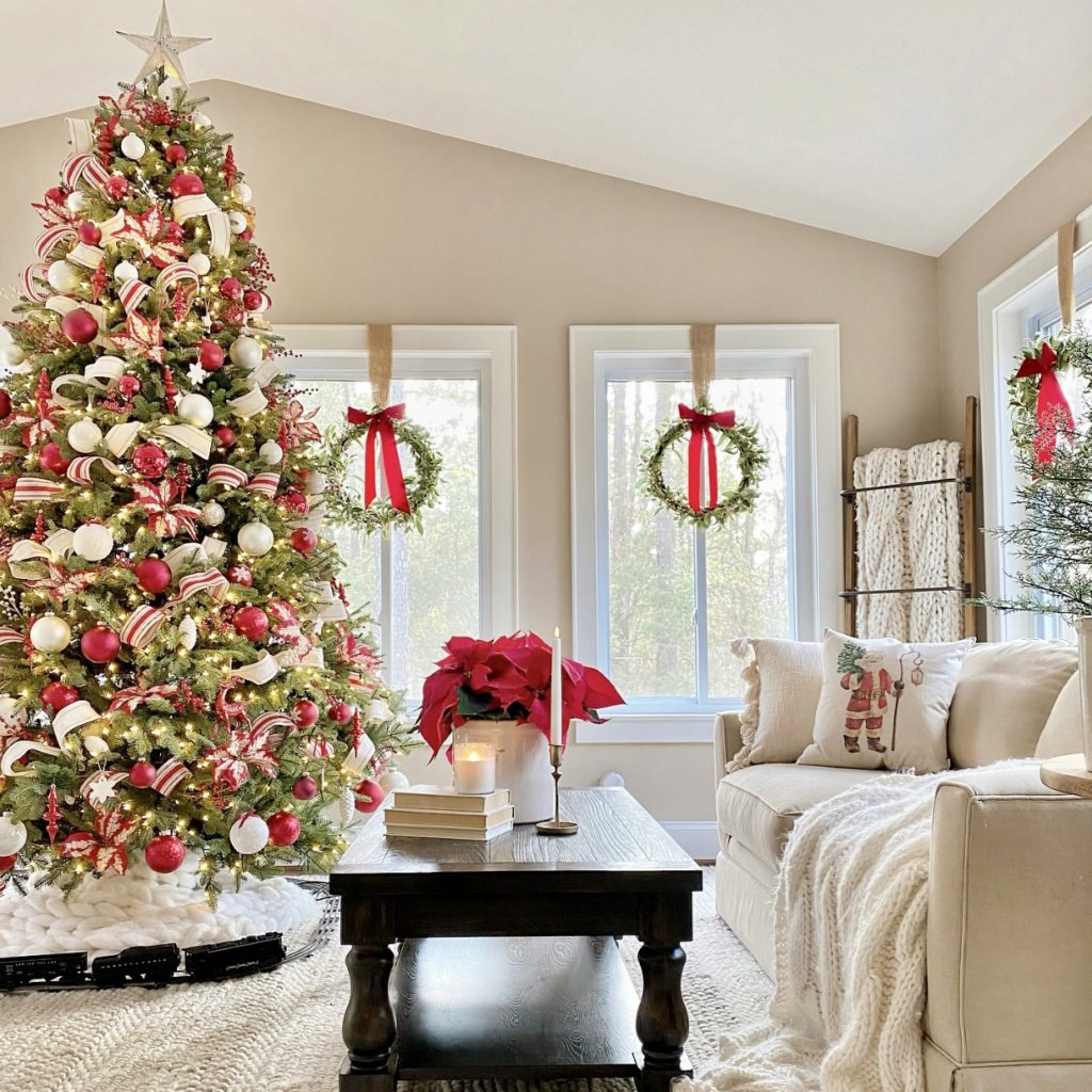 Christmas tree decorated with red and white ornaments in the living room.