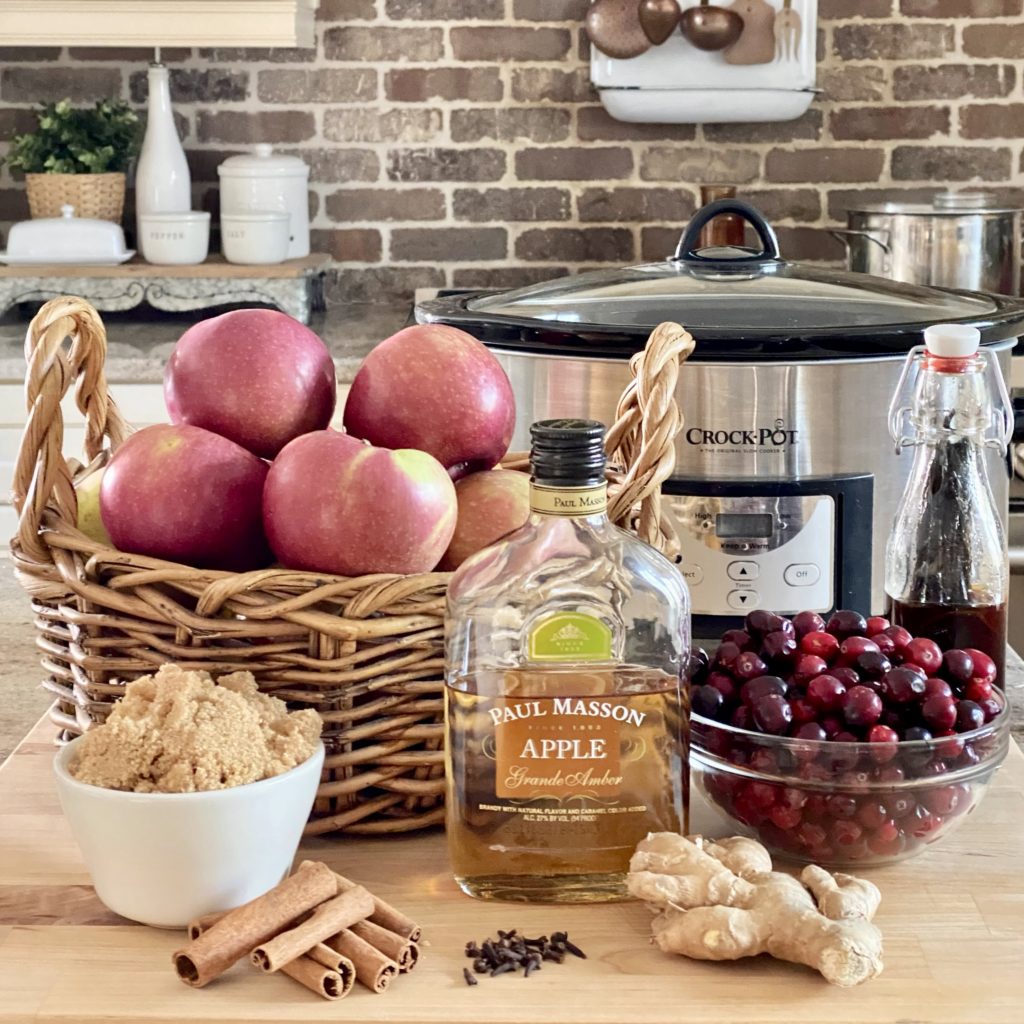 Everything you need to make holiday cranberry apple butter including apples, cranberries, ginger, apple brandy, cinnamon, brown sugar, and more.