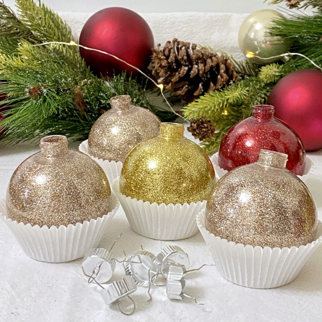 The most beautiful glitter ornaments in red, gold, and rose champagne colors drying in paper cupcake liners.
