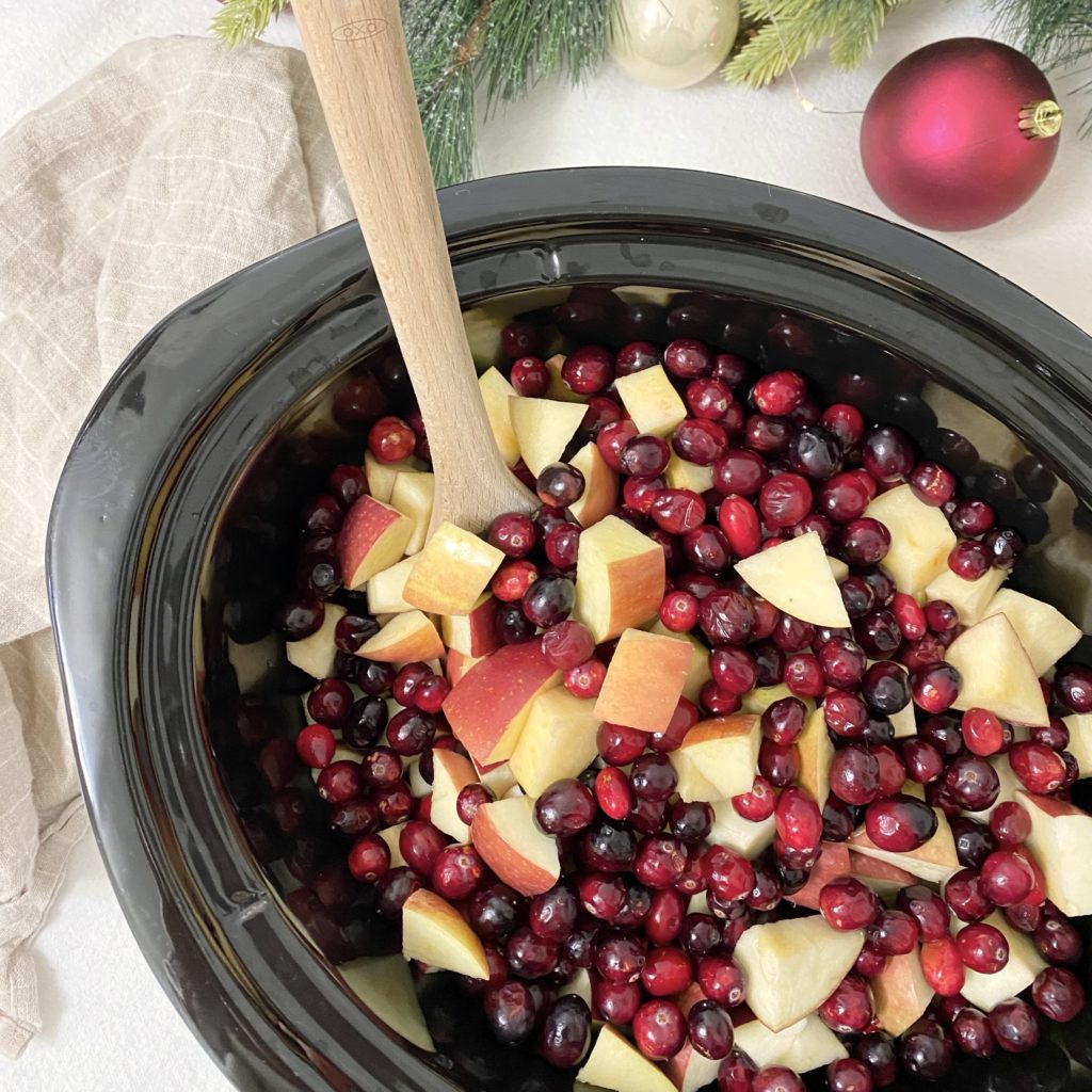 Cranberries and apples in a crockpot.