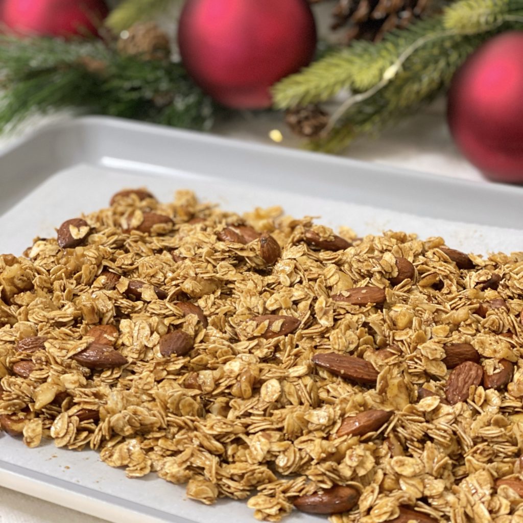 Granola spread out on a baking sheet ready to go into the oven.