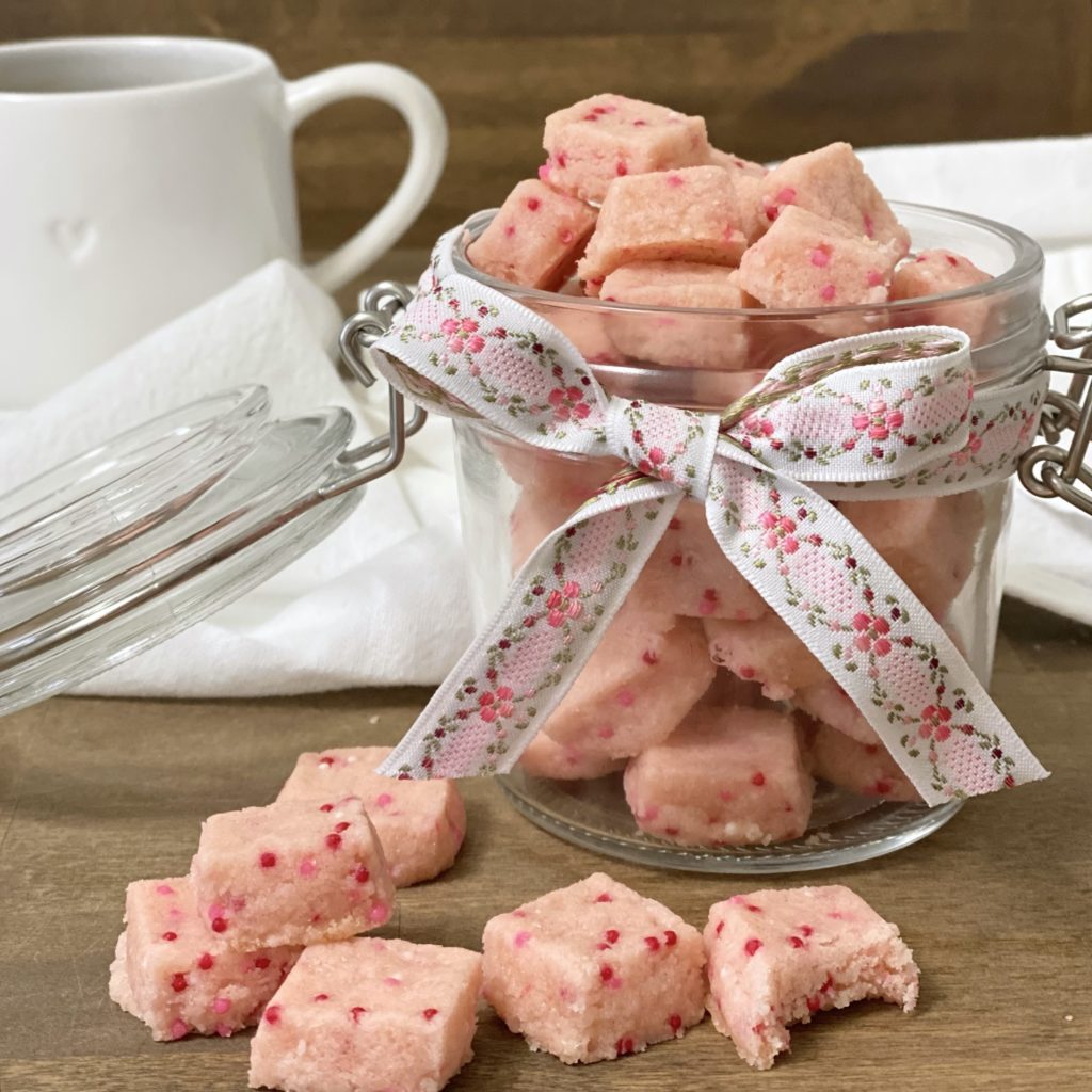 Sweet Valentine's Shortbread Bites in a jar with a ribbon around it.