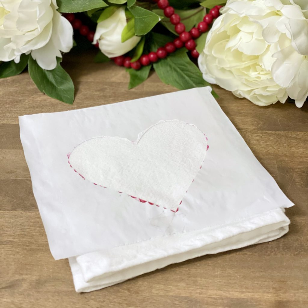 Heart template ironed on a white dish towel.