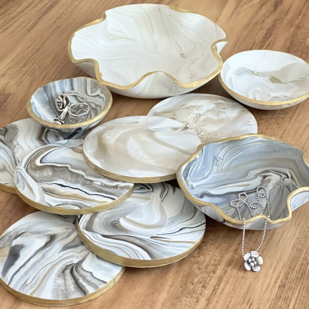 Marbleized polymer clay coasters, and trinket dishes on a table.