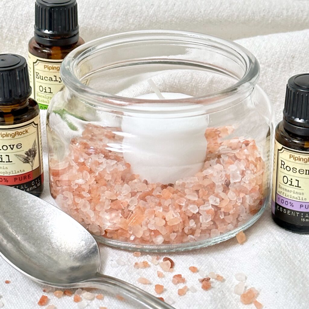 Adding the salt with essential oils in it back into the diffuser jar with votive candle in it.