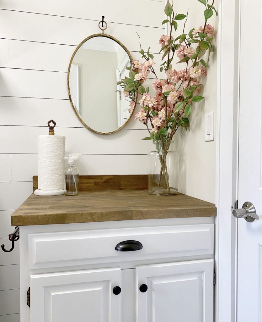 DIY plank wall, faux shiplap on the wall behind the folding table in the laundry room.