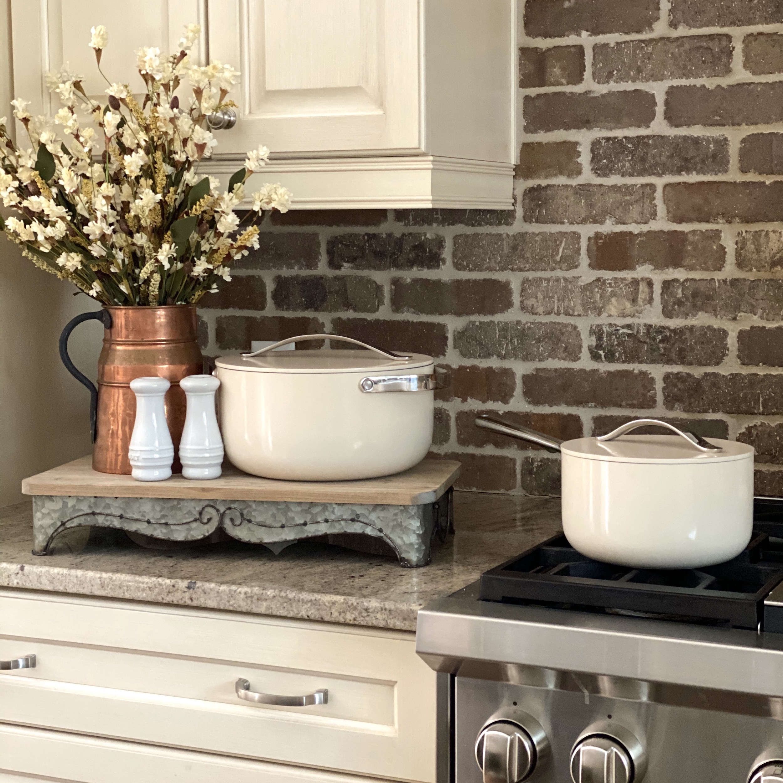 Cream Caraway pots displayed on the stove and counter.