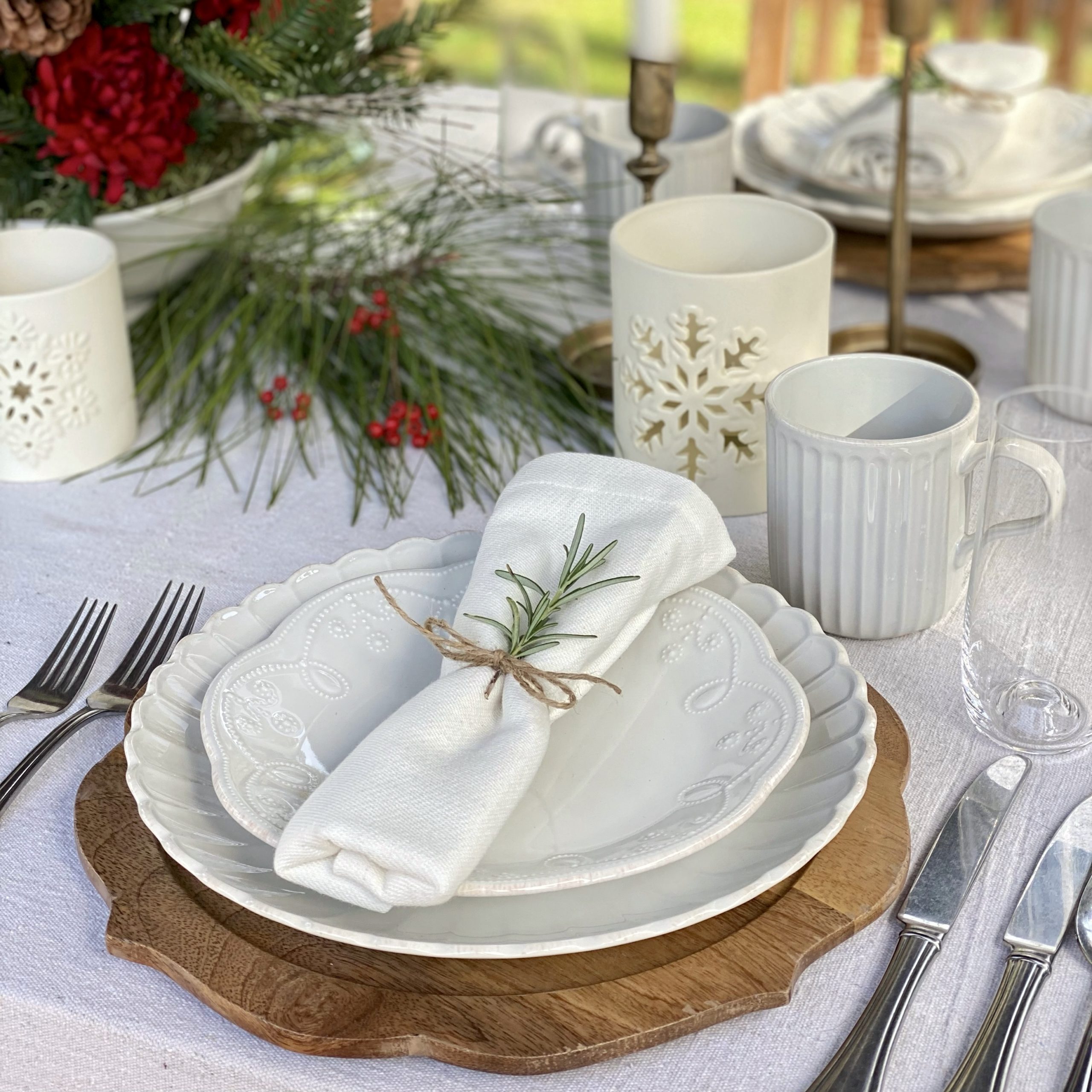 Christmas table seeing featuring Lenox dishes and candle holders.