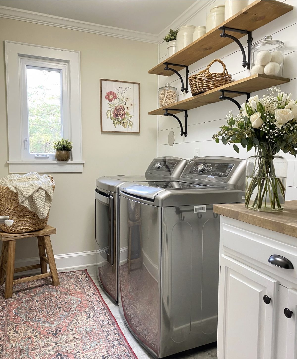Laundry room with rug on the floor and open shelving.
