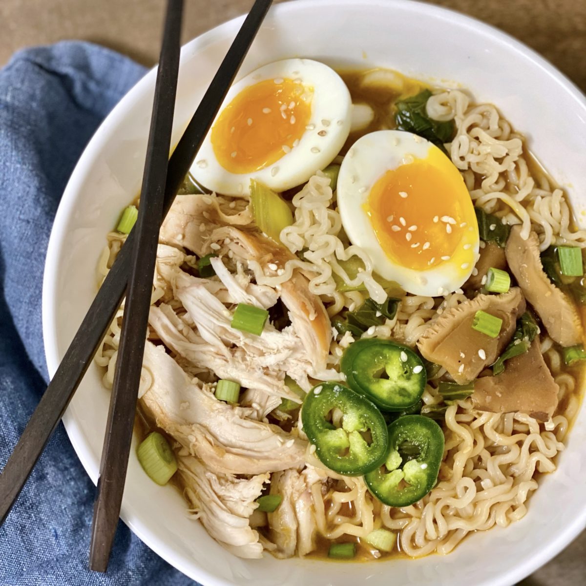 Easy Weeknight Chicken Ramen in a white bowl with chopsticks on the side.